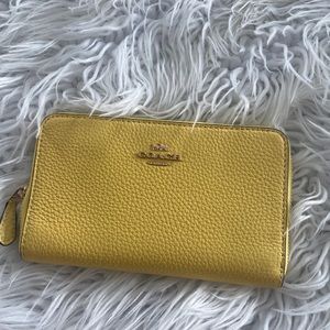 Coach yellow pebble leather wallet.  Never used. Still have tags